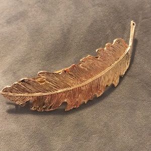 Gold feather barrette.